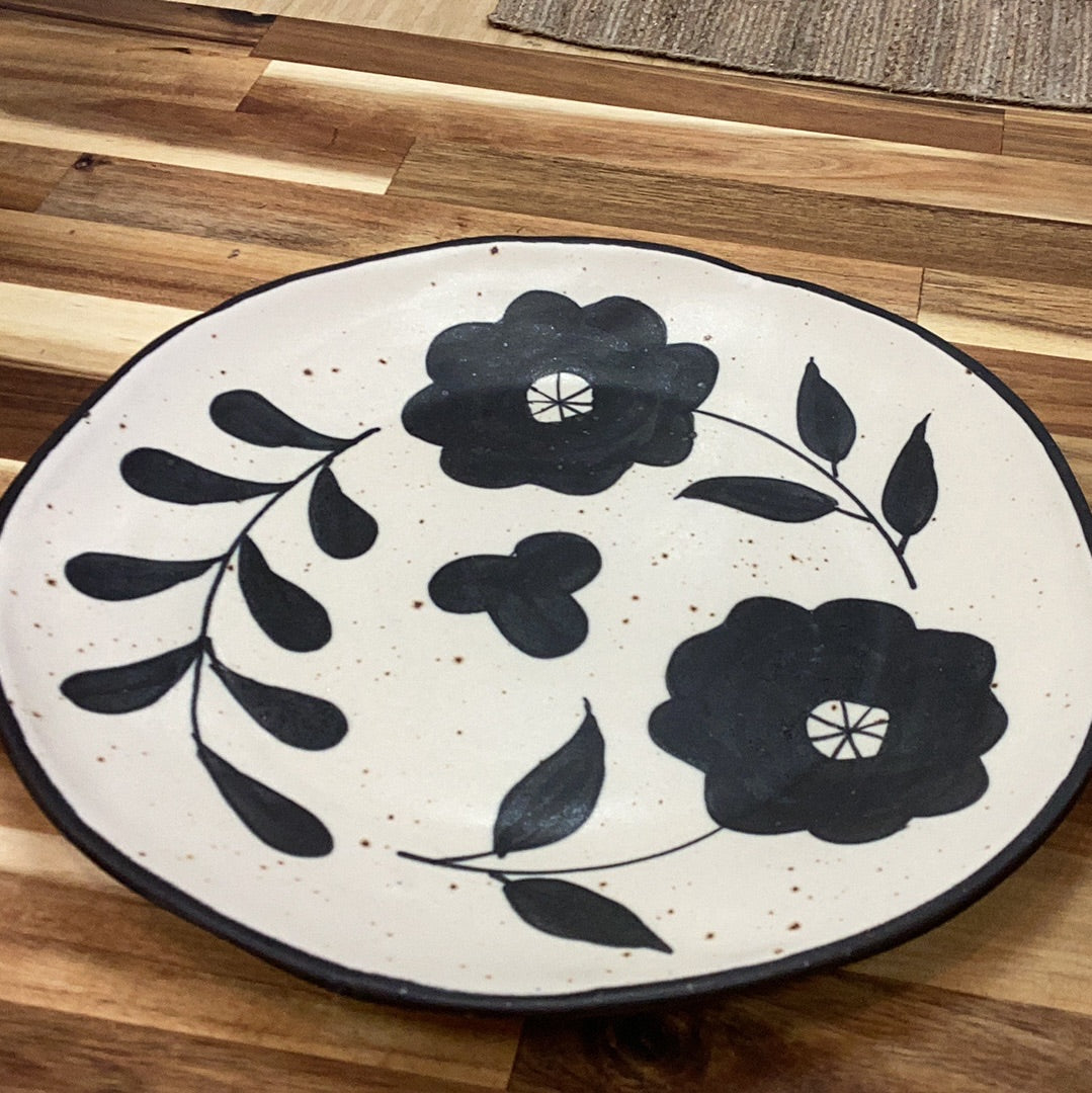 Hand painted stoneware plate with floral design…matte black and cream color…speckled
