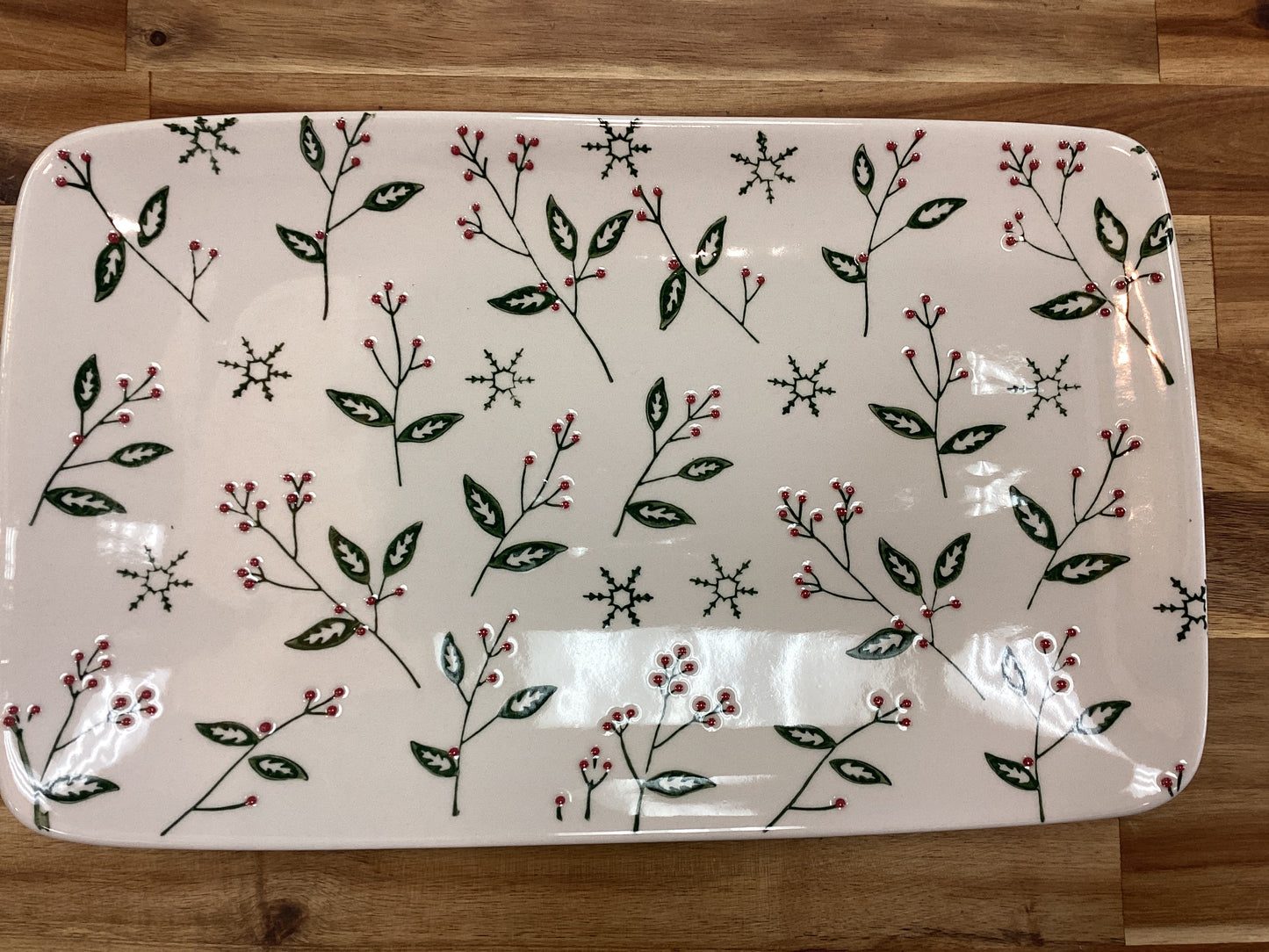 Platter with green leaves, red berries