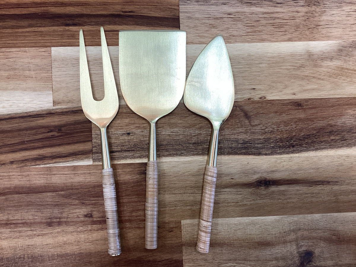 Cheese knifes in a bag…gold with rattan handle