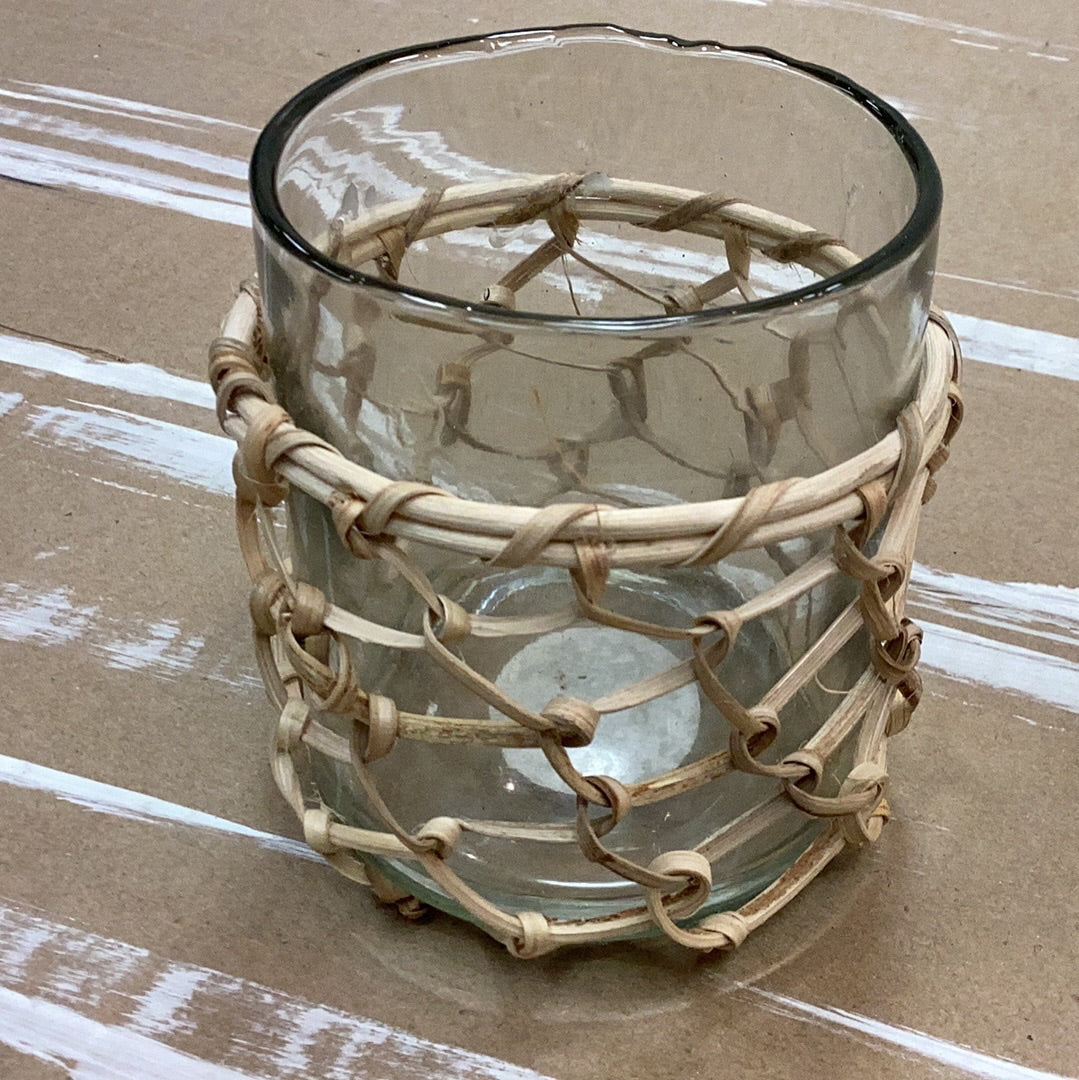 Glass rattan wrapped votive holder with woven rattan sleeve